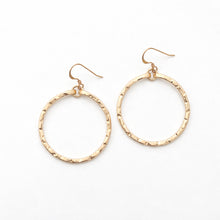 Gold hoop earrings on a white background