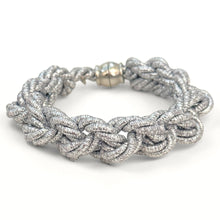 Silver braided bracelet on a white background