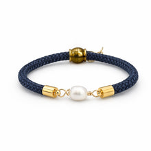 Navy blue braided bracelet with gold accents and a pearl bead on a white background