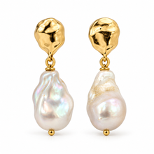 A pair of gold and baroque pearl drop earrings on a clean white background. Each earring features a textured, organic-shaped gold top piece with a small gold connector and a large, irregular white baroque pearl dangling below.