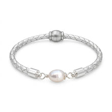 Silver bracelet with a pearl bead on a white background