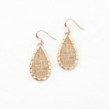 Teardrop-shaped earrings with woven pattern on a white background