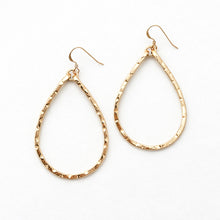 Gold teardrop earrings on a white background