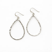 Pair of silver teardrop earrings on a white background