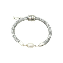 Silver bracelet with a pearl on a white background