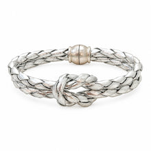 A silver braided bracelet with a knotted center detail and a polished round clasp, shown on a plain white background.