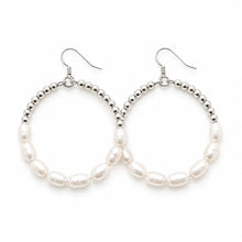 Large silver-tone bead hoop earrings with white pearl accents.