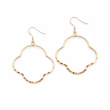 Gold hoop earrings on a white background
