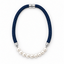 A necklace featuring a dark navy blue braided cord and a row of white freshwater pearls, finished with silver-toned metal caps on a white background.