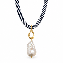 A necklace featuring a twisted navy and white striped cord and a baroque pearl pendant in a gold setting, shown against a plain white background.
