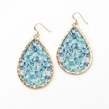 Teardrop-shaped earrings with floral pattern and gold frame on a white background