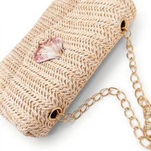 Beige woven handbag with a gold chain strap on a white background