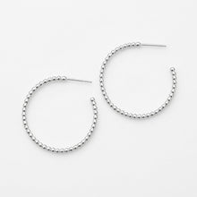Pair of silver hoop earrings on a white background