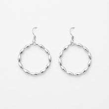 Pair of silver hoop earrings on a white background