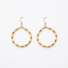 Gold hoop earrings on a white background