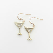 Gold martini glass earrings with gemstone accents on a white background