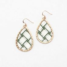 Teardrop-shaped earrings with green and gold pattern on a white background