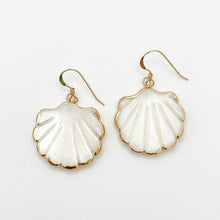 Shell-shaped earrings with gold accents on a white background