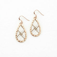 Teardrop-shaped earrings with rose gold frames on a white background
