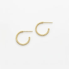 Gold hoop earrings on a white background