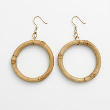 Pair of round bamboo earrings on a white background