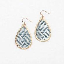 Teardrop-shaped earrings with woven pattern and gold outline on a white background