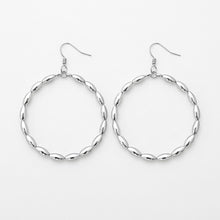 Pair of silver hoop earrings on a white background