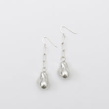Pair of silver teardrop earrings on a white background