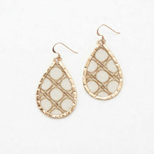 Teardrop-shaped earrings with gold frames and beige mesh design on a white background