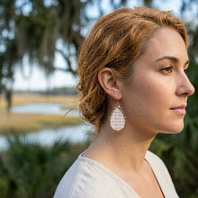 Woman wearing earrings with a natural background