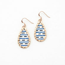 Teardrop-shaped earrings with blue and white striped design on a white background