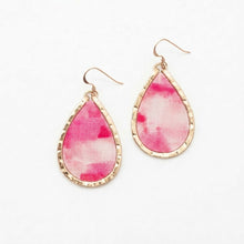 Teardrop-shaped earrings with pink and white pattern and gold accents on a white background