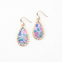 Teardrop-shaped earrings with colorful pattern and gold frame on a white background