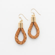 Pair of braided wooden earrings with gold tops on a white background