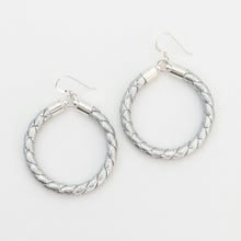 Pair of silver hoop earrings on a white background