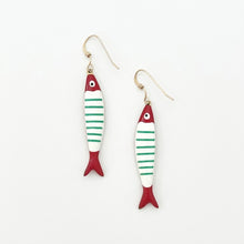 Fish-shaped earrings with red, white, and green stripes on a white background