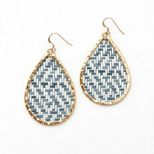Teardrop-shaped earrings with geometric pattern and gold frame on white background