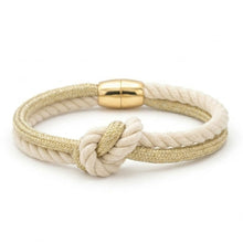 Nautical-style bracelet with a gold clasp on a white background