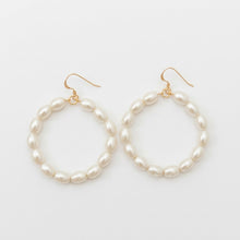 Pearl hoop earrings on a white background