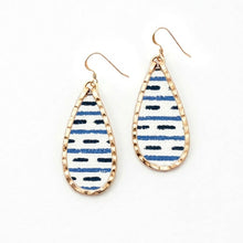 Teardrop-shaped earrings with blue and white striped design on a white background