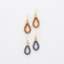 Set of earrings with braided and striped designs on a white background