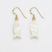 Pair of white shell earrings with gold hooks on a light gray background