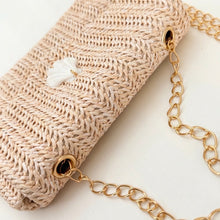Beige woven handbag with a gold chain on a white background