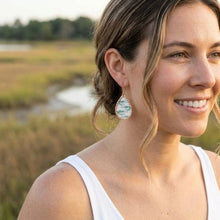 Woman wearing earrings with a natural background