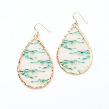 Teardrop-shaped earrings with gold frames and green and white patterned stones on a white background