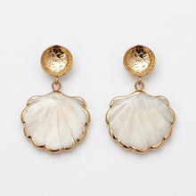 Shell-shaped earrings with gold accents on a white background