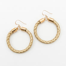 Gold hoop earrings on a white background
