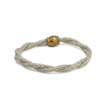 Bracelet with braided design and gold clasp on a white background