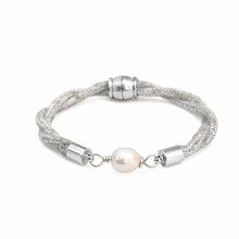 Silver bracelet with a pearl on a white background